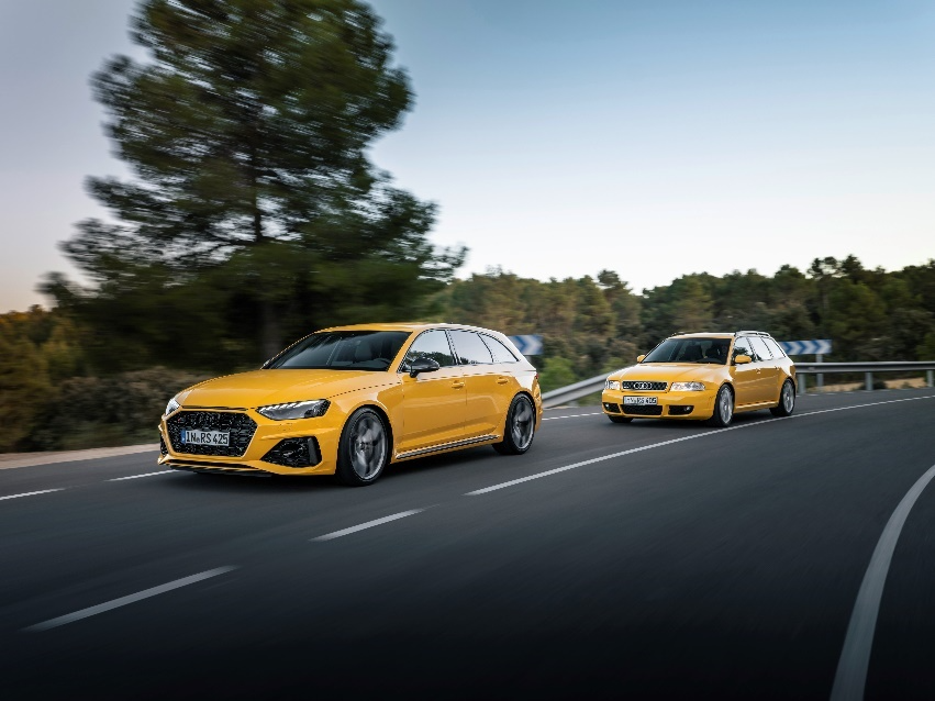 Two yellow cars on a road 
Description automatically generated